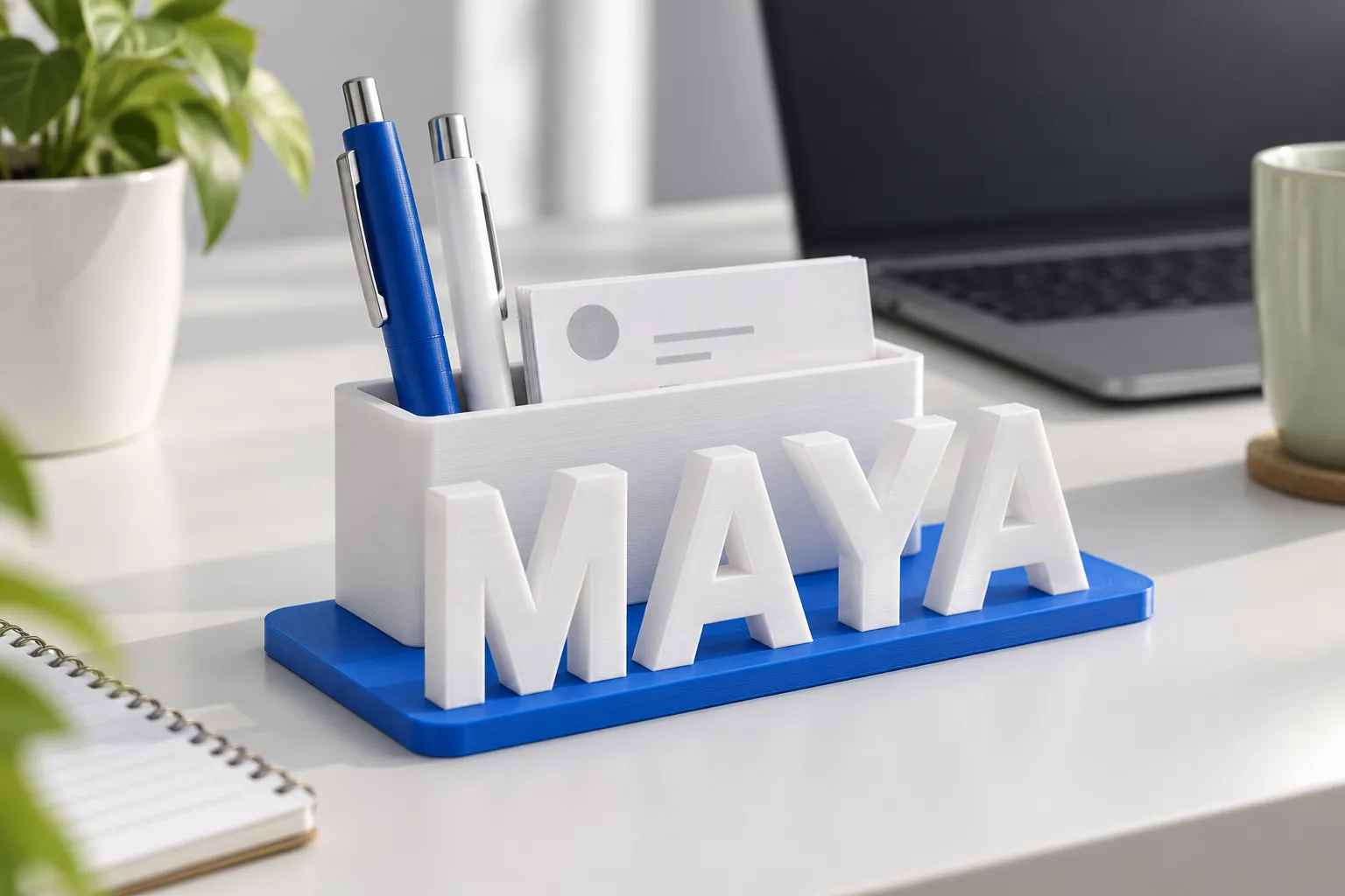 A desk name plate with pens and a business card on an office desk